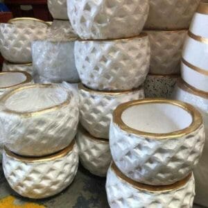 Displays of White Pot with Gold Accent (4") are elegantly arranged in a Dapitan store, perfect for enhancing any home decor.