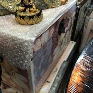 The Floral Chest - Pink, encapsulating the unique allure of Dapitan's charm, is thoughtfully cushioned in bubble wrap and plastic on a shelf, bringing an extra touch of intrigue to your home.