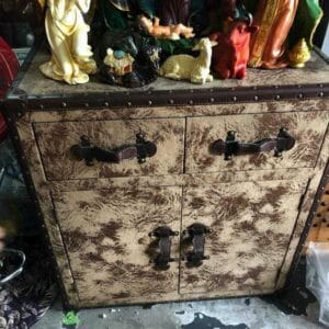 This rustic-look chest from Dapitan showcases religious figurines and animals on top, bringing a touch of unique decor to your home.