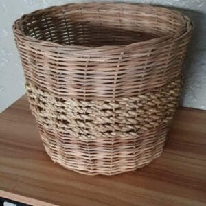 Large Planter Basket basket The small Black Container, perfect for home decor, sits gracefully on a wooden table against a concrete wall, reminiscent of Dapitan's artisanal charm.