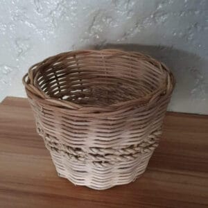 Small Basket Planter Basket basket A charming Black Container - Small, perfect as home decor, sits on a wooden surface against a textured wall, adding a touch of Dapitan-inspired elegance.