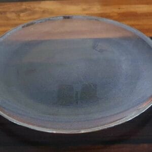 A Black Container - Small, with its round glass lid, rests gracefully on a dark wooden surface, adding a touch of home decor elegance reminiscent of Dapitan craftsmanship.
