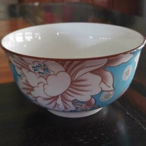 5-inch bowls – Floral Blue Bowl Set bowls A small black container sits gracefully on a wooden table, adding a touch of elegant decor to your home.