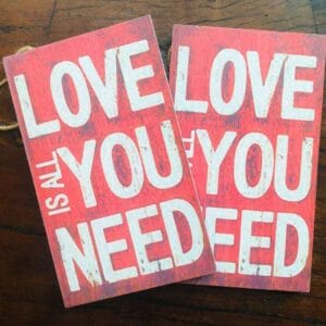 Love is all you need Big 8” x 4.75” – inspirational sign Home Decor home decor Two red wooden plaques, ideal for home decor, feature the phrase "LOVE IS ALL YOU NEED" in bold white capital letters. The product is named the "Love is all you need Big 8” x 4.75” - inspirational sign.