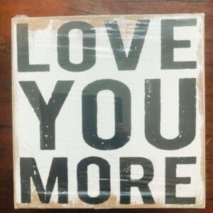 A delightful 6” x 6” wooden sign from Dapitan, adorned with the bold black phrase "LOVE YOU MORE," serves as an ideal home decor piece to express your affection to loved ones.