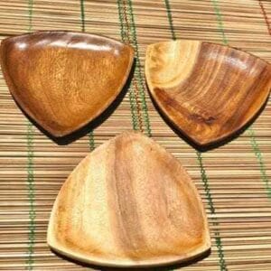 Soft Edge Triangle Wooden Plate Plates dinnerware The Soft Edge Triangle Wooden Plates, elegantly arranged on a bamboo mat background, add a touch of Dapitan-inspired decor to your home.