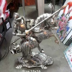 A silver Knight & Horse statue, featuring a knight on horseback with a lance, is elegantly poised on the gray floor, capturing their timeless bond.