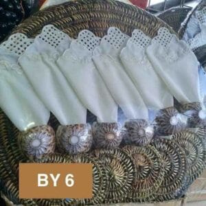 Table Napkin Set featuring six woven placemats, white lace-trimmed napkins, and decorative ring holders, ideal for enhancing your home decor.