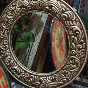The Framed Mirror Pasley, featuring a decorative frame, enhances your home decor with an air of elegance. Positioned on the floor amidst other stunning pieces, it infuses any space with a touch of Dapitan charm.