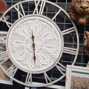 The Metal White Floral Clock from Dapitan features a decorative design that makes your home decor truly unique.