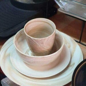 The Plate, Saucer, Bowl & Cup Set with a marbled pattern adds a distinctive touch to any dapitan-inspired home, beautifully showcased on a store shelf.