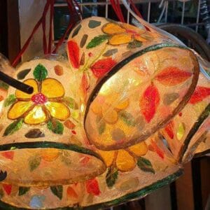 Christmas ornaments with floral patterns illuminate the decor of a shop display, adding a unique touch reminiscent of Dapitan's vibrant home markets.