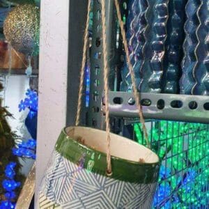 The hanging ceramic planter, measuring 6 inches and featuring geometric patterns, is showcased in the home decor aisle next to blue glass vases, reflecting the artisanal charm typical of Dapitan craftsmanship.