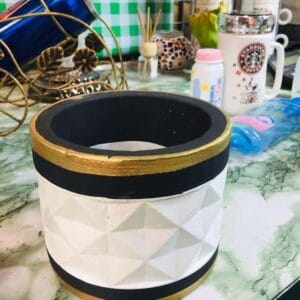 A "Pot with Accent Black and Gold Lid" introduces a hint of Dapitan decor charm to the cluttered green and white countertop.