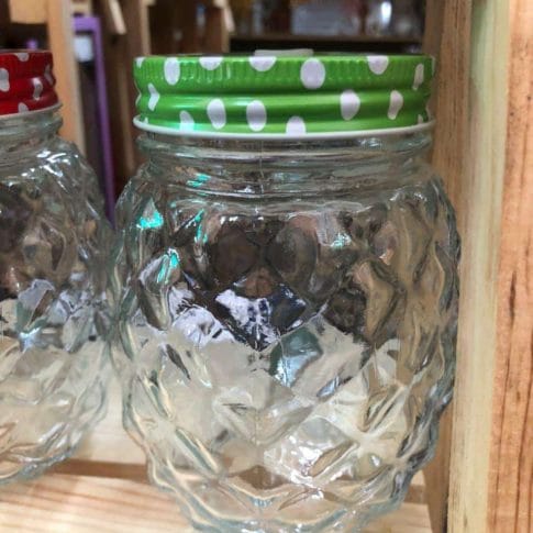 photo_2020-09-03_11-45-53 A delightful pineapple-shaped glass jar mug with a lid and handle adds a whimsical touch to your home decor as it sits elegantly on a wooden shelf, evoking the style of Dapitan finds.