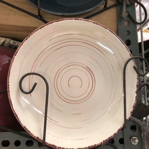 photo_2020-09-03_12-25-47 The Glossy Round Ceramic Plate, featuring a white base with a red spiral pattern, is displayed upright on a metal shelf, adding a touch of sophisticated decor to any home.