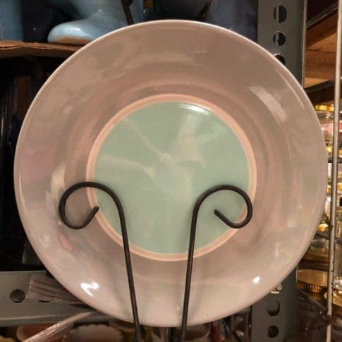 photo_2020-09-03_12-25-53 A Glossy Round Ceramic Plate, ideal for dapitan-inspired decor, is showcased on a metal stand within a store setting.