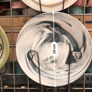 Marble-designed Round Plates Plates dinnerware Marble-designed round plates are elegantly displayed on a metal rack, adding a touch of decor to your home. The middle plate, measuring 25 cm, captures the artisanal charm reminiscent of Dapitan.