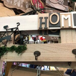 Introducing the Wall Decor Hook: a delightful piece of wall décor showcasing a small bicycle, vibrant moss, and a HOME sign on wood. It features three convenient hooks and is perfect for infusing your home with Dapitan-inspired charm.